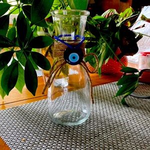 Glass vase with evil eye bracelet also plant trimming